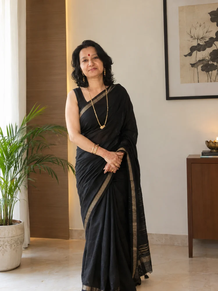 Sunita Singh, creator of Inner Architecture Reprogramming, standing in a black sari.